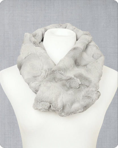 A light gray faux fur infinity scarf draped on a white mannequin torso against a textured gray background. 
Photo by Shannon Fabrics [image_link]