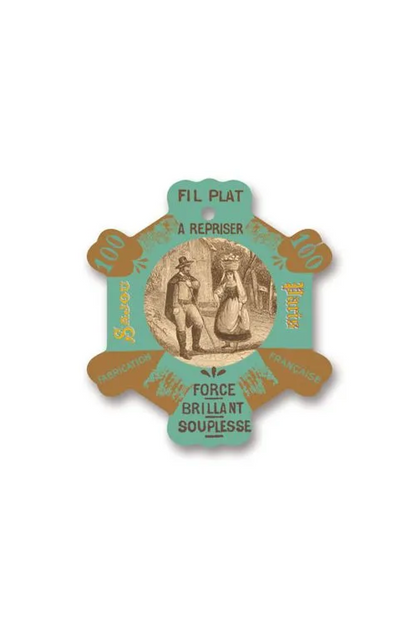 A vintage French thread card for 'Fil Plat', featuring a light green and gold star-shaped layout with an illustration of a couple in the center, placed on a white background.
Photo by Sajou.fr [additional_image_link]