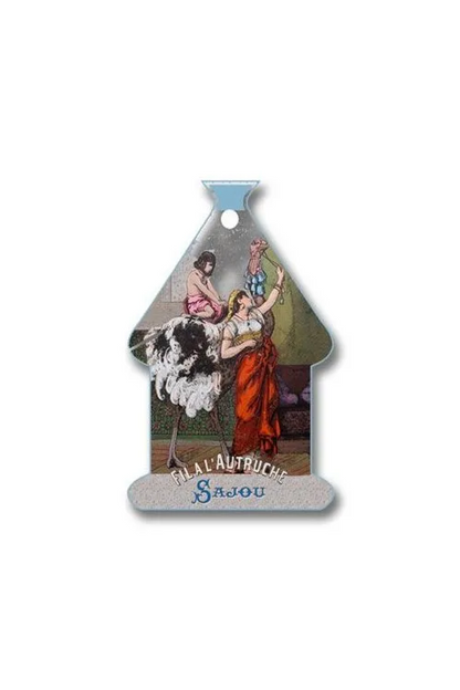 A vintage French thread card shaped like a house, featuring an illustration of women dancing with an ostrich and the text 'FIL A L'AUTRUCHE Sajou' on a white background.
Photo by Sajou.fr [additional_image_link]