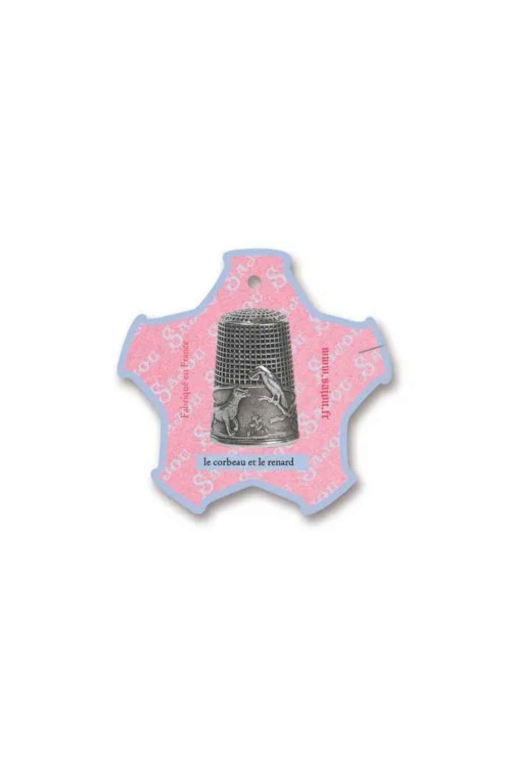 A small decorative thread card shaped like a five-pointed star, featuring a pink center with a silver thimble illustration and French text, placed on a white background.
Photo by Sajou.fr [additional_image_link]