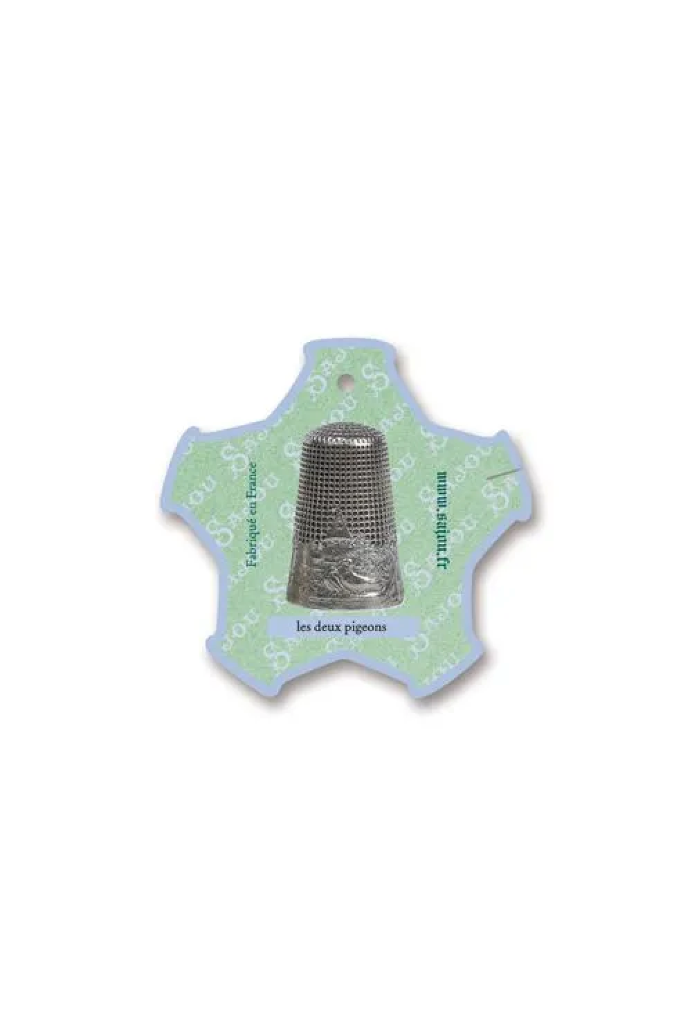 A silver metal thimble displayed on a light green and white decorative thread card, placed on a white background.
Photo by Sajou.fr [additional_image_link]