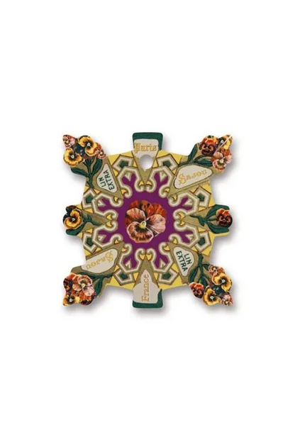 A decorative, symmetrical cross-shaped thread card featuring a central purple medallion with floral motifs and ornate gold, green, and cream baroque-style scrollwork.
Photo by Sajou.fr [additional_image_link]