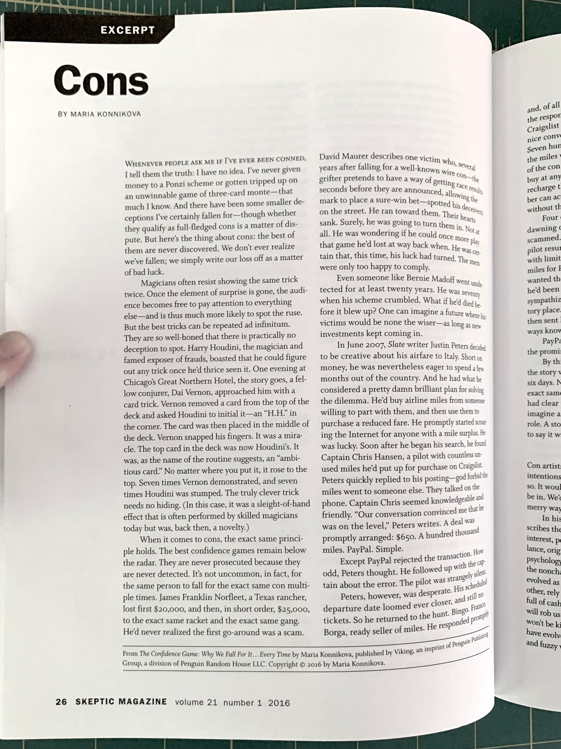 An open magazine or book spread showing a printed excerpt page with the title 'Cons' and multiple columns of text. The left page has a dark green background, and the right page is white with black text.
[additional_image_link]