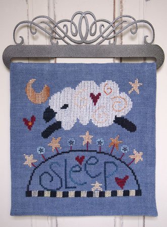 Cross-stitched design of a cloud with a sheep and 'sleep' text on a blue background.
Photo by SamSarah Studio Designs [image_link]