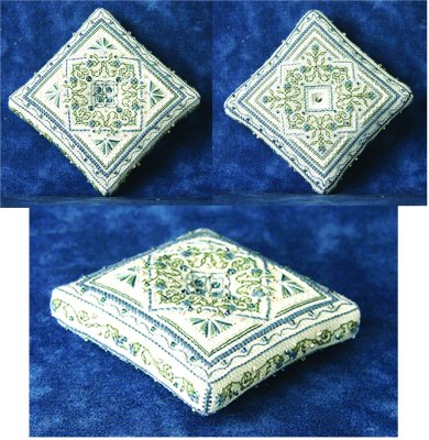 A sparkling blue pincushion cross stitch embroidery kit, with diagrams and instructions shown for a completed pincushion top and a partially completed bottom.
Photo by The Sweetheart Tree [image_link]