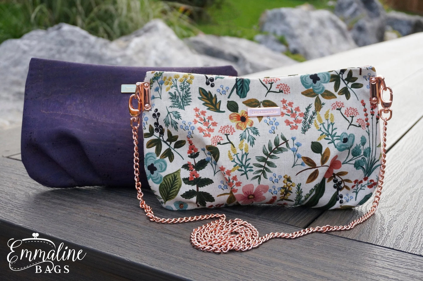 Floral patterned handbag with a chain strap on a wooden surface, with 'Emmaline Bags' branding.
Photo by Emmaline Bags [additional_image_link]