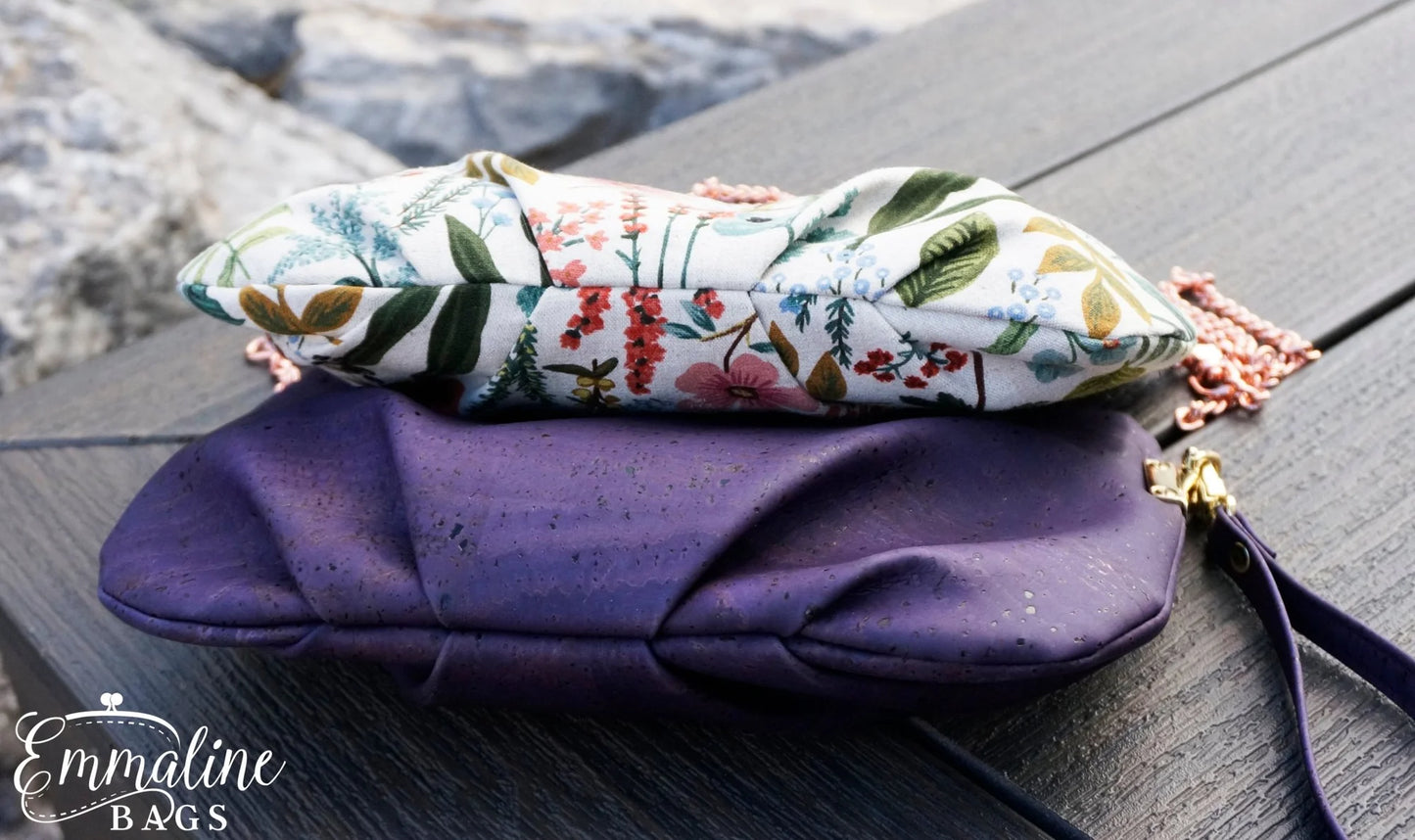 Floral-patterned pouch on a purple clutch on a wooden surface.
Photo by Emmaline Bags [additional_image_link]