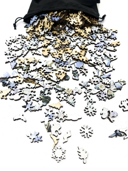A jigsaw puzzle depicting a winter scene with a path, fence, and trees, predominantly in shades of white and blue by Claude Monet.
Photo by Nautilus Puzzles [additional_image_link]