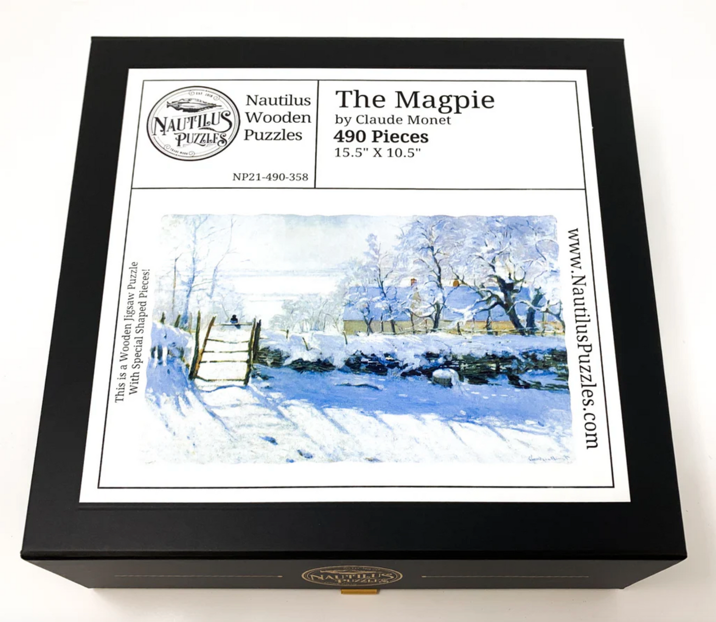 A jigsaw puzzle depicting a winter scene with a path, fence, and trees, predominantly in shades of white and blue by Claude Monet.
Photo by Nautilus Puzzles [additional_image_link]
