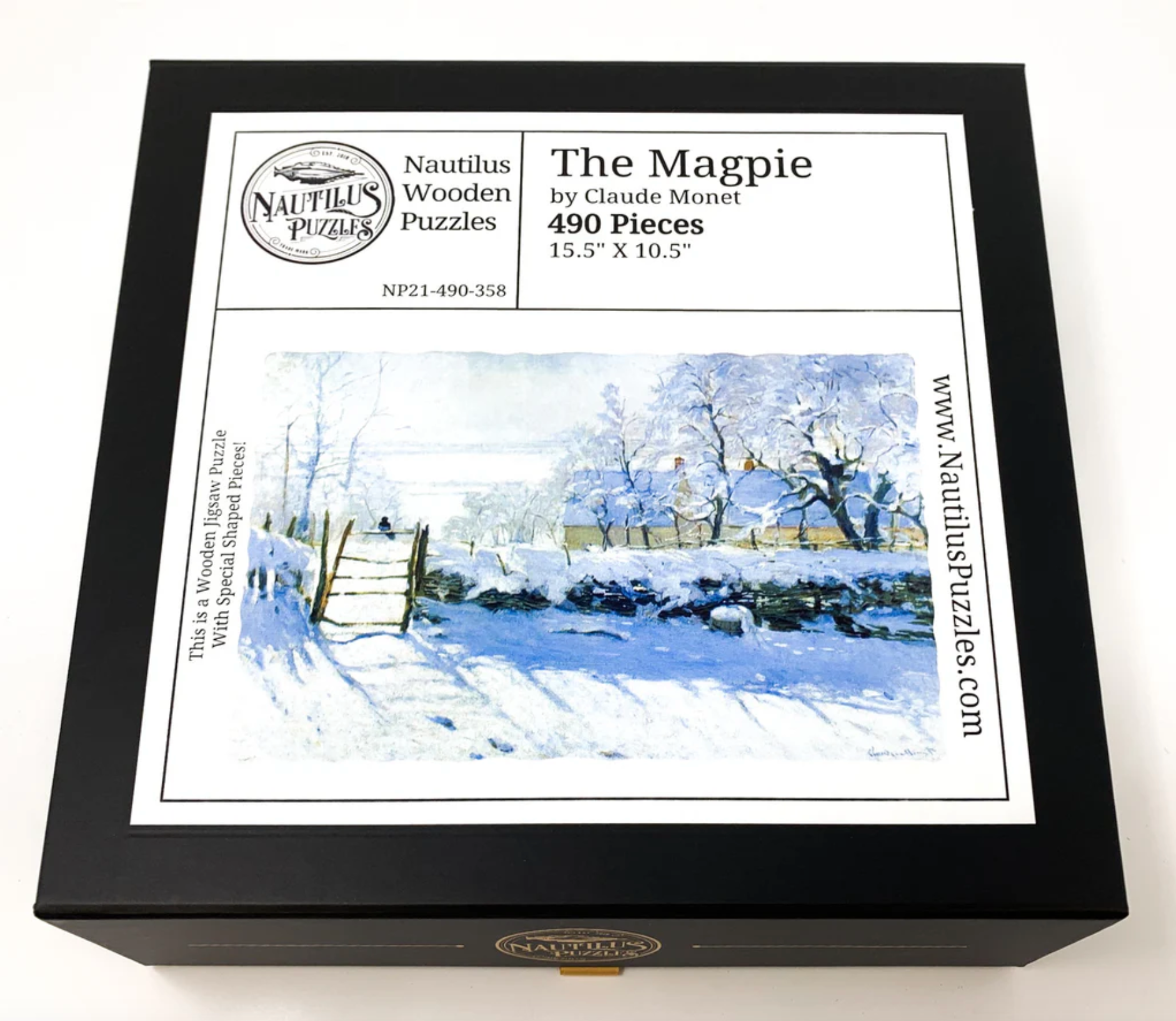 A jigsaw puzzle depicting a winter scene with a path, fence, and trees, predominantly in shades of white and blue by Claude Monet.
Photo by Nautilus Puzzles [additional_image_link]
