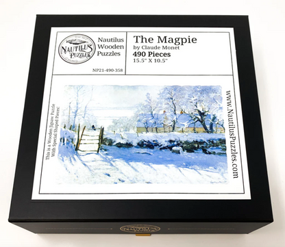 A jigsaw puzzle depicting a winter scene with a path, fence, and trees, predominantly in shades of white and blue by Claude Monet.
Photo by Nautilus Puzzles [additional_image_link]