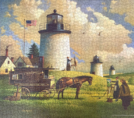A jigsaw puzzle depicting a painting of the Three Sisters Lighthouse with a horse-drawn carriage, a man painting, and a woman with a sewing basket in the foreground.
Photo by Karen King [image_link]