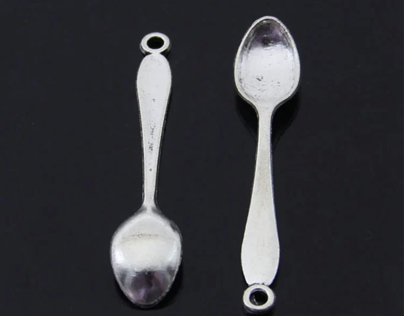 Two silver spoons on a black background
[additional_image_link]