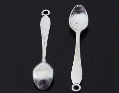 Two silver spoons on a black background
[additional_image_link]