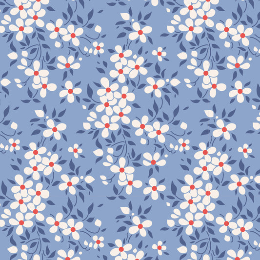 A repeating floral pattern featuring small white flowers with red centers and dark blue leaves on a dusty blue background.
Photo by Tildafabrics.com [image_link]