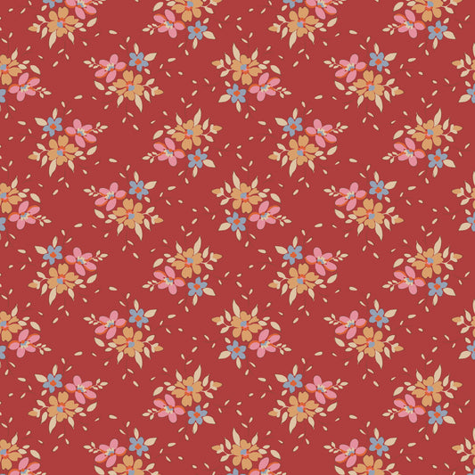 A repeating floral pattern on a warm red background, featuring small pink, blue, yellow, and beige flowers with scattered beige petals.
Photo by Tildafabrics.com [image_link]