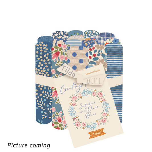 A collection of Tilda fabric precuts in a Summer and Ocean Blues theme, including various patterns and shades of blue.
Photo by Tildafabrics.com [image_link]