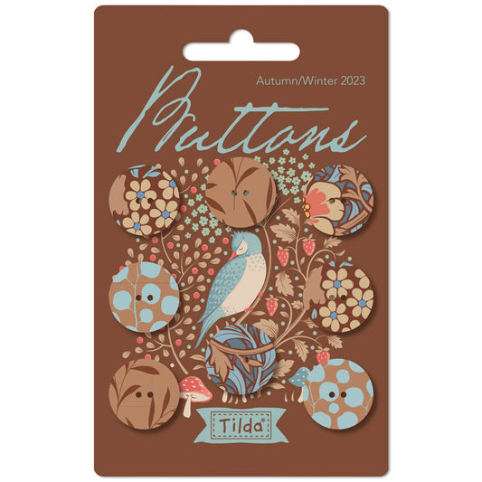 Pack of Tilda brand fabric covered buttons featuring floral and nature motifs, suitable for autumn/winter 2023 collection, in a brown color palette.
Photo by Tildafabrics.com [image_link]