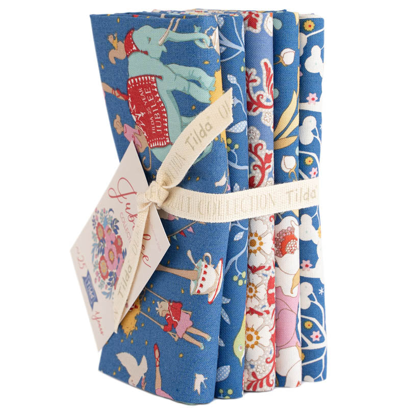 Set of three folded fabric swatches with colorful patterns on a white background, featuring the brand 'Tilda'.
Photo by Tildafabrics.com [image_link]