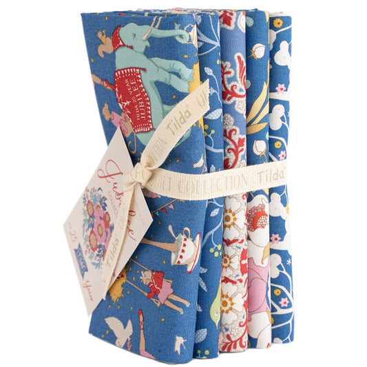 Set of three folded fabric swatches with colorful patterns on a white background, featuring the brand 'Tilda'.
Photo by Tildafabrics.com [image_link]