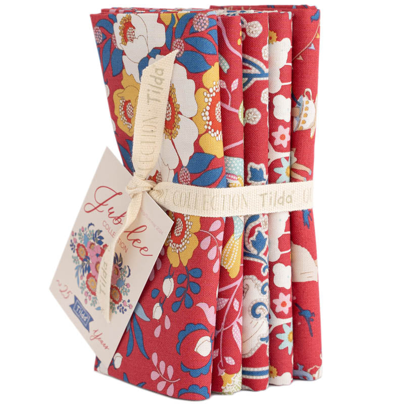 Set of floral-patterned fabric rolls with a visible brand tag on a white background.
Photo by Tildafabrics.com [additional_image_link]