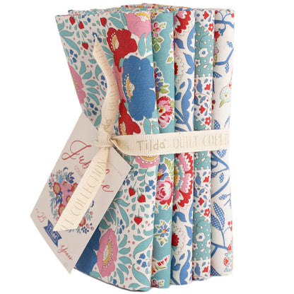 Set of colorful fabric swatches with a floral pattern, tied together with a ribbon.
Photo by Tildafabrics.com [additional_image_link]