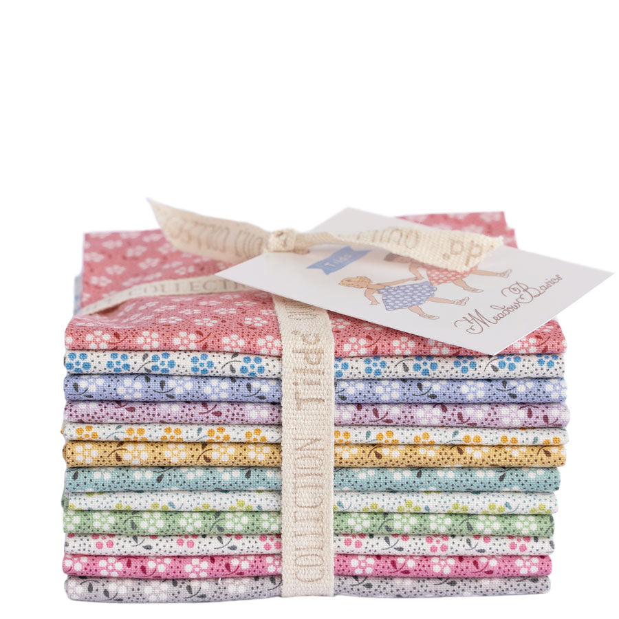A stack of Tilda Meadow collection fabric bundle tied with a cream ribbon and paper tag, shown on a plain white background.
Photo by Tildafabrics.com [additional_image_link]
