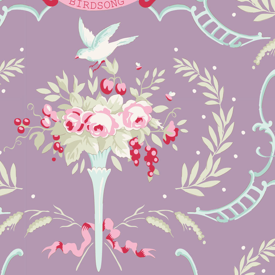 A repeating vintage-style floral pattern on a lavender background, featuring a bouquet of pink and white flowers, red berries, a white bird, and pale blue decorative scrollwork.
Photo by Tildafabrics.com [image_link]