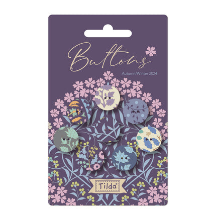 Pack of Tilda Sanctuary fabric covered buttons in various shades of blue, featuring floral and geometric patterns.
Photo by Tildafabrics.com [image_link]