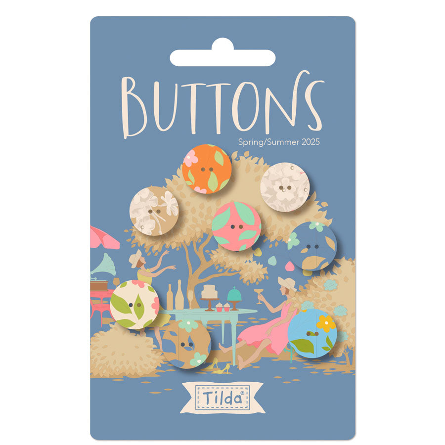 Packaged buttons with colorful designs on a blue card featuring 'Tilda' branding.
Photo by Tildafabrics.com [image_link]