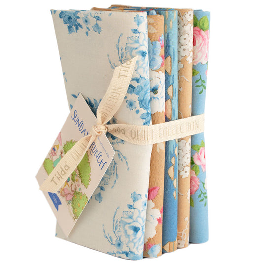 Set of floral-patterned notebooks tied with a ribbon on a white background.
Photo by Tildafabrics.com [image_link]