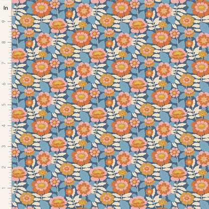 Yardage of Tilda Wallflower Beverly Blue fabric featuring a floral print with orange, pink, and yellow flowers on a blue background.
Photo by Tildafabrics.com [image_link]