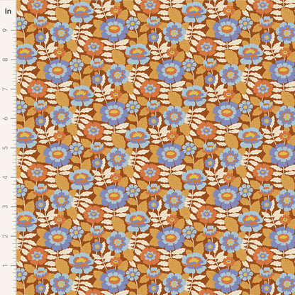 Yardage of floral print fabric in caramel, blue, and beige colors with a meter scale on the side.
Photo by Tildafabrics.com [image_link]