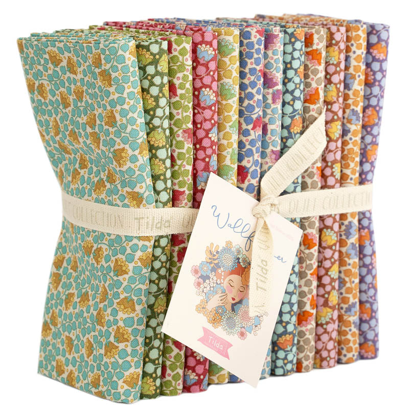 Set of colorful patterned fabrics with a tag on a white background.
Photo by Tildafabrics.com [additional_image_link]
