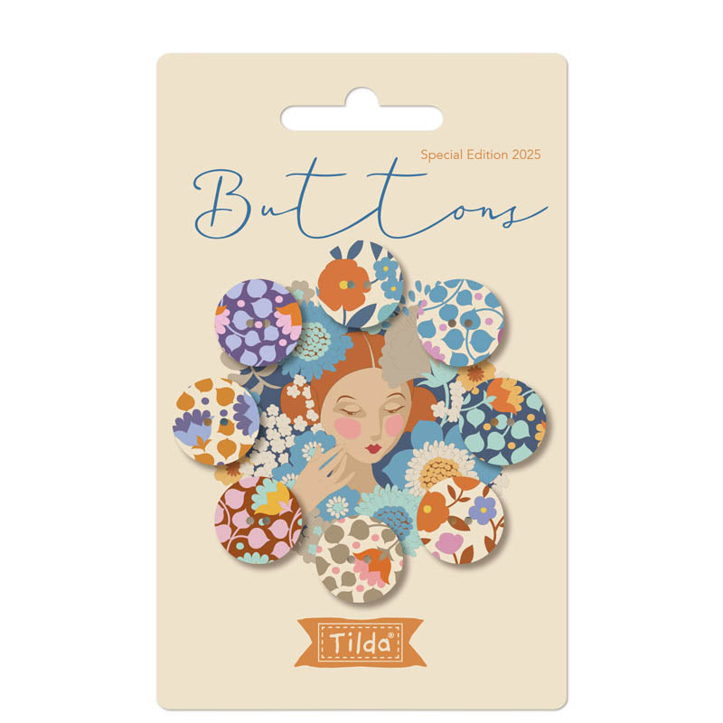 Packaging of Tilda Wallflower Buttons featuring blue and purple fabric covered buttons with floral patterns, name and count indicated on the front.
Photo by Tildafabrics.com [image_link]