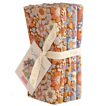Five fat quarter bundles of Tilda Wallflower fabric with floral patterns in various brown colors, tied together with a tag displaying the brand and product name.
Photo by Tildafabrics.com [additional_image_link]
