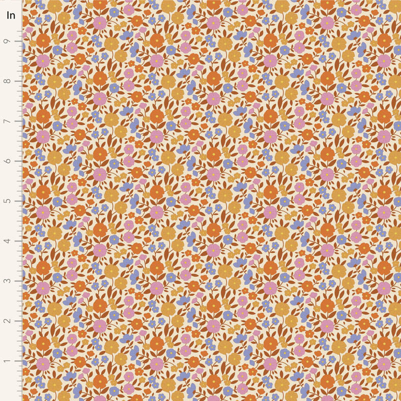 Yardage of Tilda Wallflower Janice Caramel fabric featuring a floral print with a mix of caramel, blue, ginger, ochre, and thistle colors on a fabric background.
Photo by Tildafabrics.com [image_link]