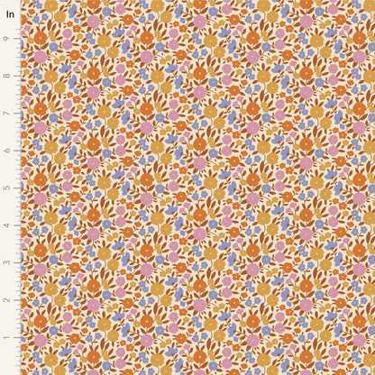 Yardage of Tilda Wallflower Janice Caramel fabric featuring a floral print with a mix of caramel, blue, ginger, ochre, and thistle colors on a fabric background.
Photo by Tildafabrics.com [image_link]
