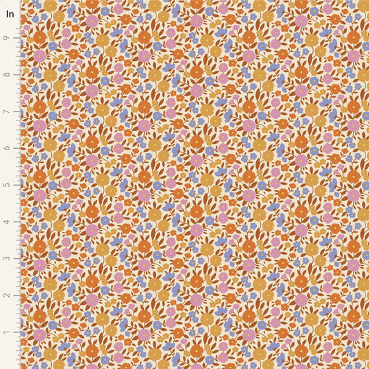 Yardage of Tilda Wallflower Janice Caramel fabric featuring a floral print with a mix of caramel, blue, ginger, ochre, and thistle colors on a fabric background.
Photo by Tildafabrics.com [image_link]