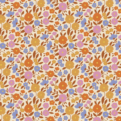 Yardage of Tilda Wallflower Janice Caramel fabric featuring a floral print with a mix of caramel, blue, ginger, ochre, and thistle colors on a fabric background.
Photo by Tildafabrics.com [additional_image_link]