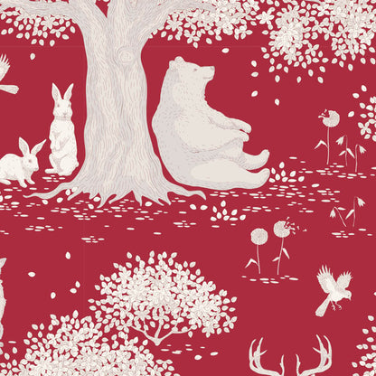A repeating woodland pattern on a deep red background featuring white silhouettes of a large tree, a seated polar bear, rabbits, flowers, and birds.
Photo by Tildafabrics.com [image_link]