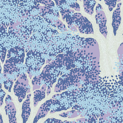 A repeating botanical pattern featuring stylized white tree branches with light blue leaves over a lavender and medium blue dotted background.
Photo by Tildafabrics.com [image_link]