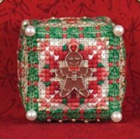 Decorative cube with Christmas pattern and gingerbread man design on a red background
Photo by JustNan.com [image_link]