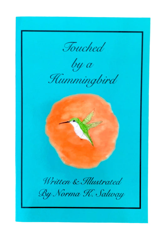 A book cover for 'Touched by a Hummingbird' featuring a blue background with an image of an orange area with a hummingbird land on it.
Photo by Karen King [image_link]