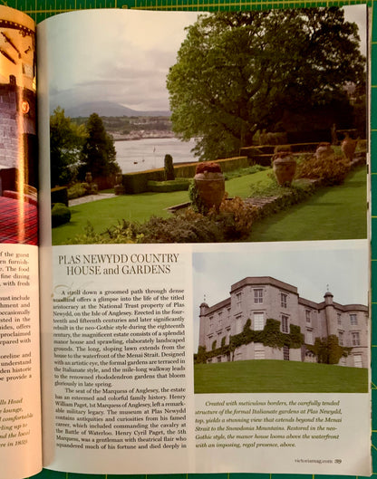 An open printed magazine or book spread showing an article about Plas Newydd Country House and Gardens, with a large outdoor garden photo on the left page and a smaller house photo on the right page.
[additional_image_link]