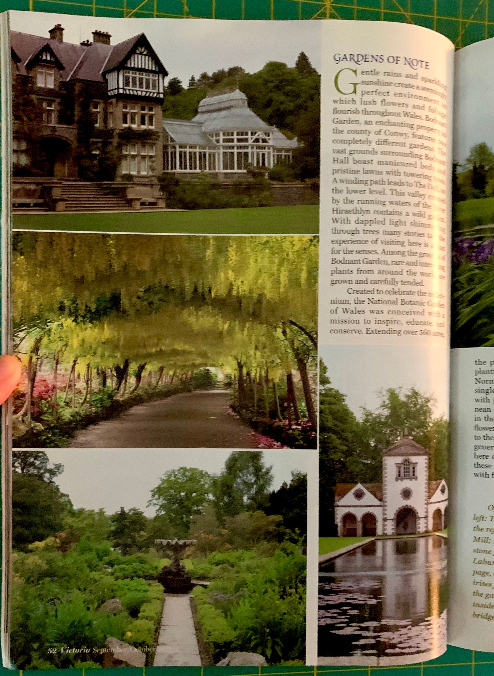 An open printed book or magazine spread showing garden photographs and an article titled 'GARDENS OF NOTE.' A hand is holding the left page edge.
[additional_image_link]