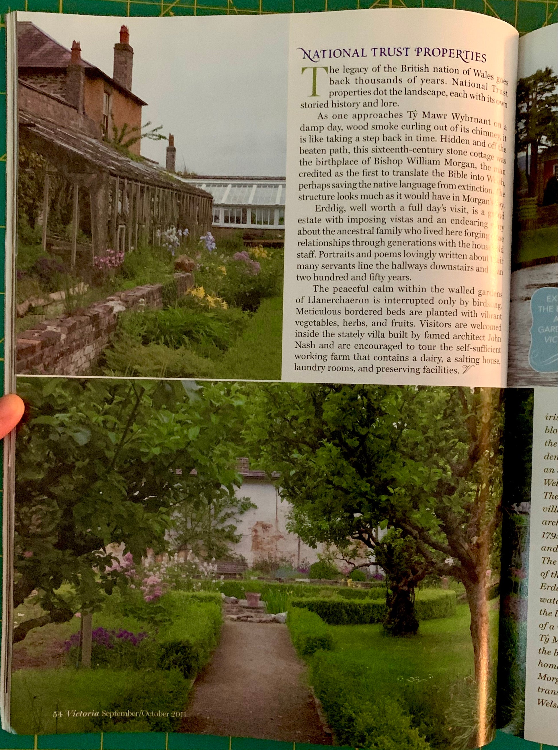 An open book showing printed pages with text and photographs, held by a hand. The visible content includes a page titled 'National Trust Properties' with a house photo on the left and a landscape photo on the right.
[additional_image_link]