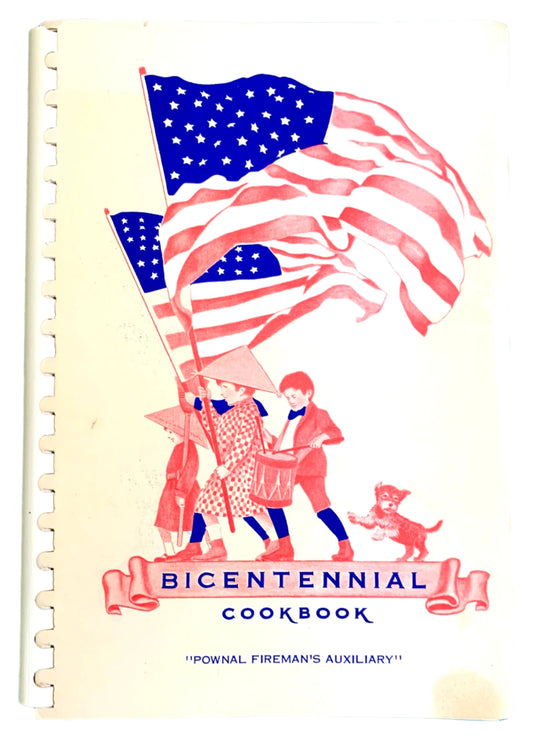 Cover of a vintage bicentennial cookbook with an illustration of the American flag, a fireman, and the Pownal Fireman's Women's Auxiliary logo.
Photo by Karen King [image_link]