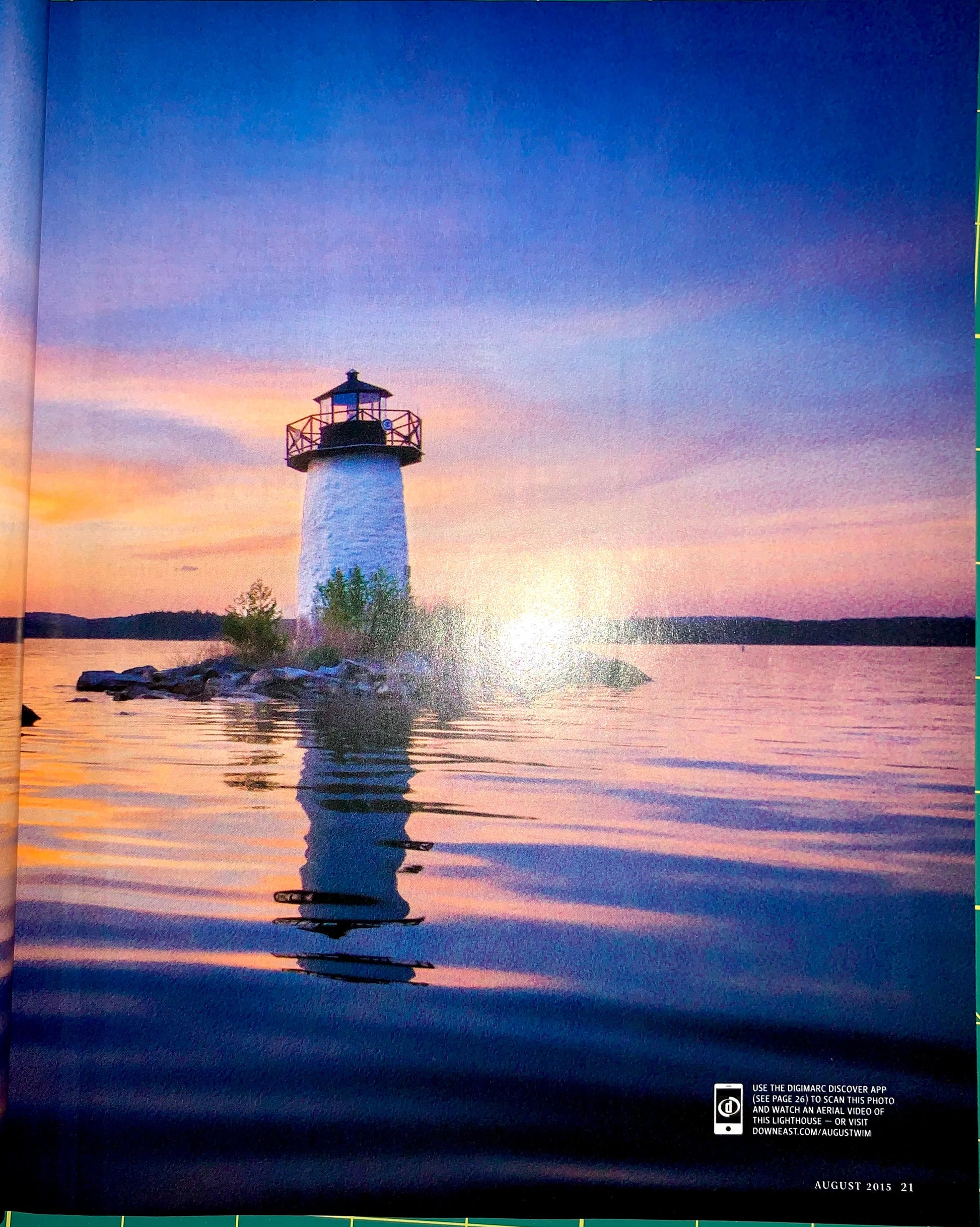 A scenic photograph of a white lighthouse on a small rocky island, surrounded by calm water under a sunset sky with blue, purple, and orange tones. Small printed text appears in the bottom right corner.
[additional_image_link]
