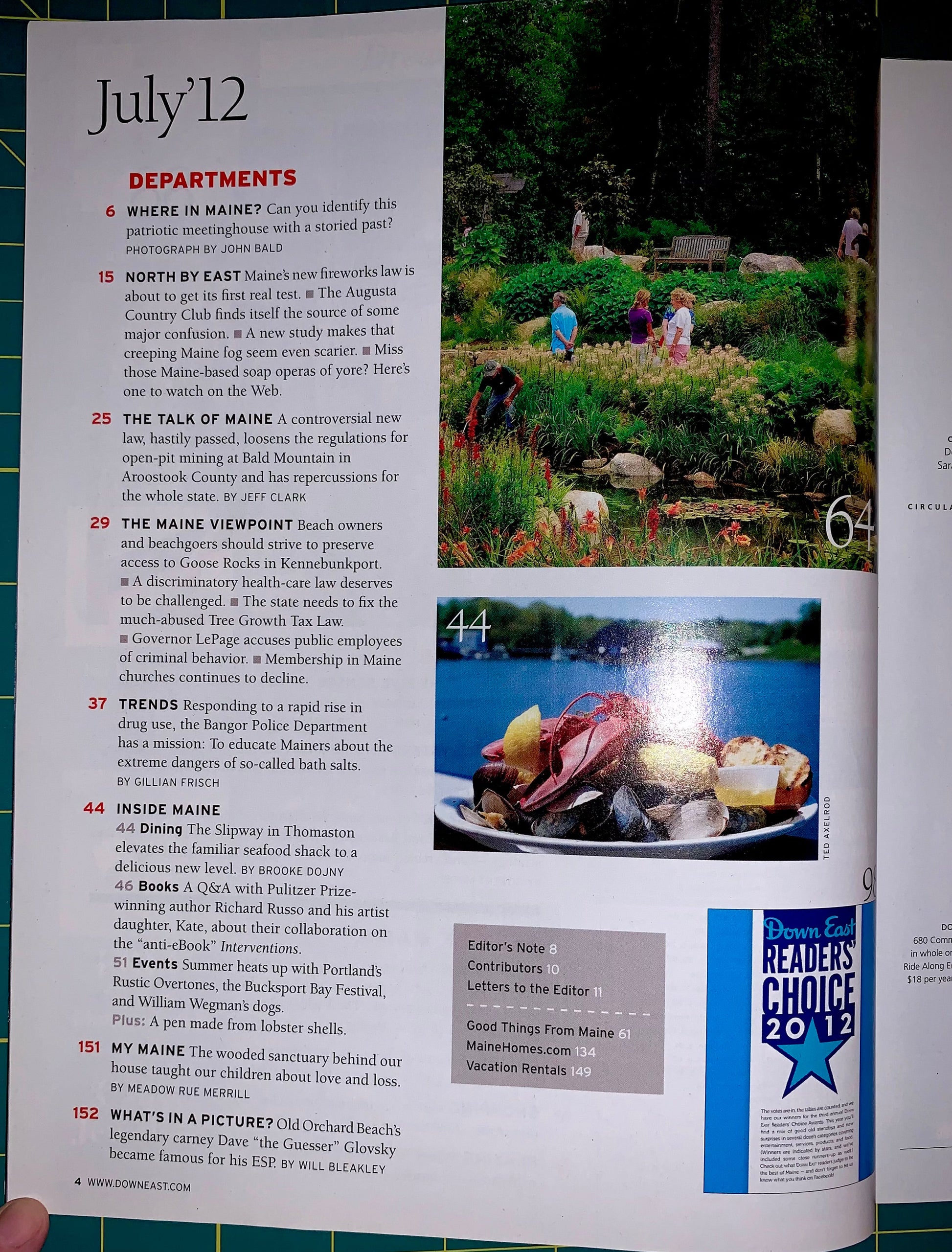 An open magazine or book page spread showing article text, a landscape photo of people in a forest, and a Reader's Choice 2012 badge. The left page has a large heading 'July 12' and department-related text, while the right page includes a scenic photo and promotional badge.
[additional_image_link]